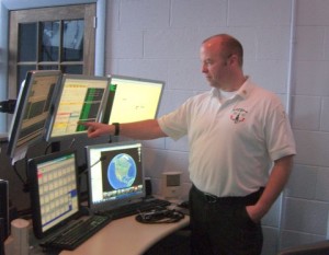 Joe Sangermano, Deputy Chief of Dublin Fire Department and Deputy Chief of Southwestern NH District Fire Mutual Aid, explains how he receives and dispatches emergency calls in his office at Mutual Aid in Keene. Photo by Ramona Branch.