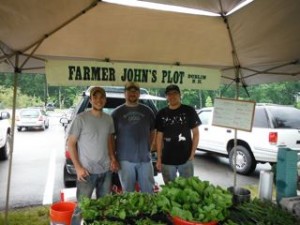 Farmer John’s Plot is manned by Garret Sundstrom (center) and John Sandri (right). Jasen Woodworth (left) is their apprentice from last year and he is the farmer they are planning on hiring next year to expand the farm.