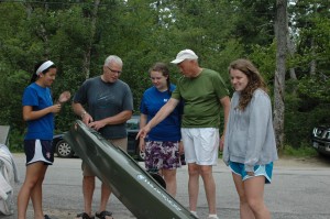 To prevent milfoil and other invasives from entering Dublin Lake from the public landing, Kenneth and Elizabeth DiCerare have their boat inspected by our Lake Hosts Olivia Thomas, Genna Weidner and Bill Goodwin. Photo by Sally Shonk