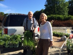 Amid the occasional rainy days of summer, Carl Webber is quoted as saying: "I don't think it's going to rain until I'm soaking wet." Here Wendy White joins Mr. Webber outside the Dublin General Store, where he often sells perennials on Saturday mornings in the summertime. Photograph by Sally Shonk