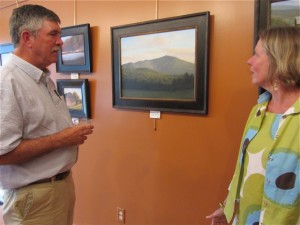 Dave Dodge, of Peterborough, discussing his Monadnock painting with Dublin resident, Mary Loftis. Photo by Sally Shonk