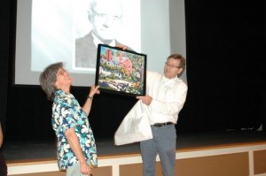 At the Dublin Historical Society’s Annual Meeting last August 24, Henry James presented a painting by Daniel Thibeault to Sarah Bauhan, who retired from the board after five years of service. Photo by Sally Shonk