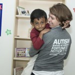 Molly holds a student in Jakarta, Indonesia, last summer.