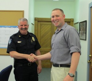 Chief Sullivan (left) welcomes Officer LaBrecque to the force.