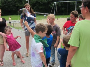 Staff and campers alike watch with glee the preparation and blowing of giant bubbles. Photos by Sally Shonk