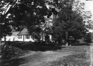 Photo taken by Mary Emerson Robbe around 1900 of her family home, the Bond/Robbe house, on the NW corner of Main Street (Route 101) and what is presumed to be Cobb Meadow Road in its original location. The original Carr’s Store, circa 1944 (founded by the Rose family in the early 1920s), would have stood in the yard to the right of the house. After the house and store burned in 1946, the Carrs rebuilt the store on the same site and built a new home across the street on Route 101. The whole Bond’s Corner intersection was reconfigured when Route 101 was widened in the early 1960s. Photo credit: Historical Society of Cheshire County