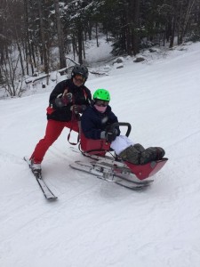 Mick assists a skier on a downhill run at Crotched Mountain.