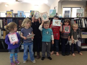 Children share their watercolor flowers after Story Time.