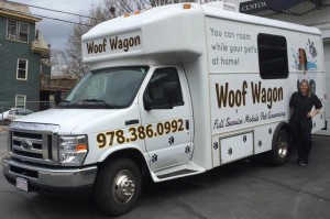 Megan Suokko stands next to one of her three “wagons” that can make home visits to wash and groom your dog.