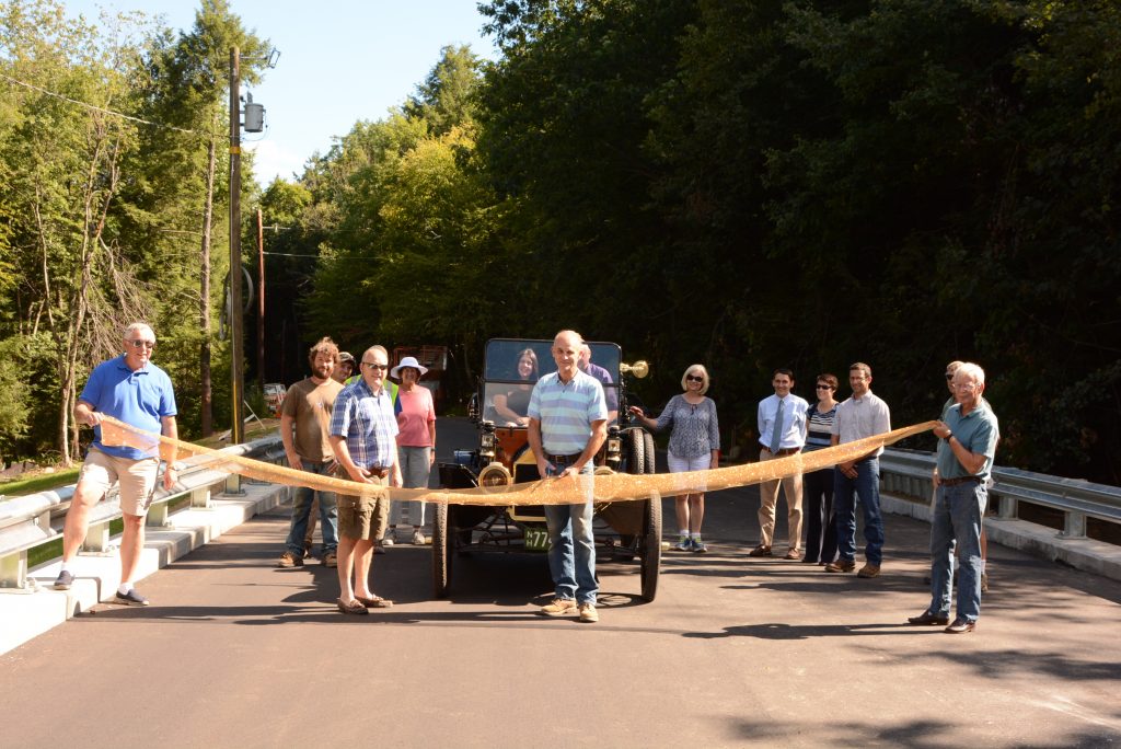 Neighbors and townspeople involved showed up for an official ribbon-cutting ceremony to re-open the Charcoal Road bridge over Charcoal Brook as road agent Brian Barden waits to drive town administrator Sherry Miller across the newly completed crossing. After several years of planning and design, construction finally commenced in early spring and was completed ahead of schedule, due to favorable weather and the efficient efforts of Cold River Bridges, the contractor. Eighty percent of the total cost was provided through the NHDOT bridge-aid program. — Sterling Abram